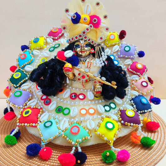 Colorful Designer Kanha Ji Dress – 3D Handmade Patches, Cowrie Beads, Mirror Work, Pom-Poms with Matching Mukut & Full Shringar Set
