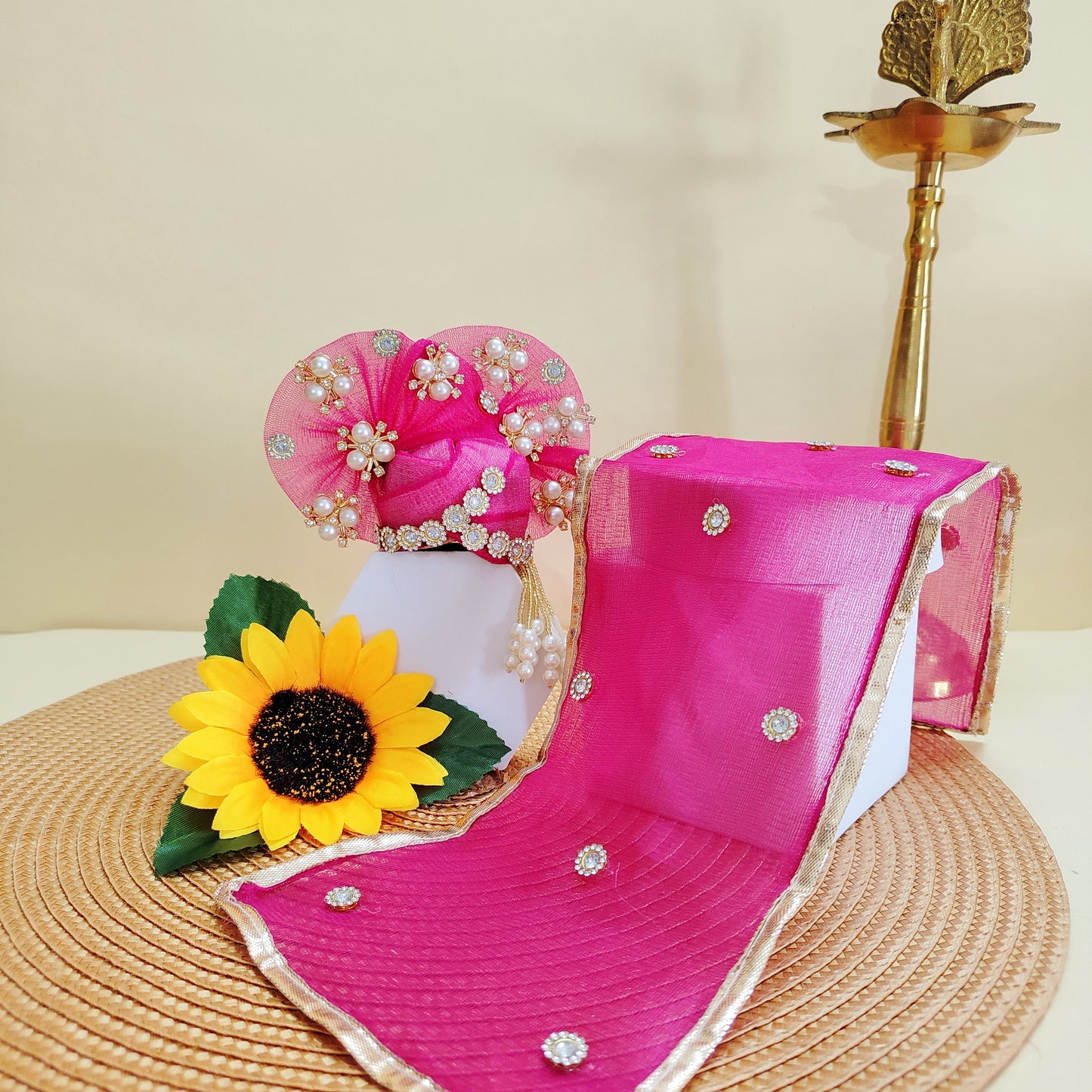 Pink mukut with floral decorations and a sunflower on a beige background