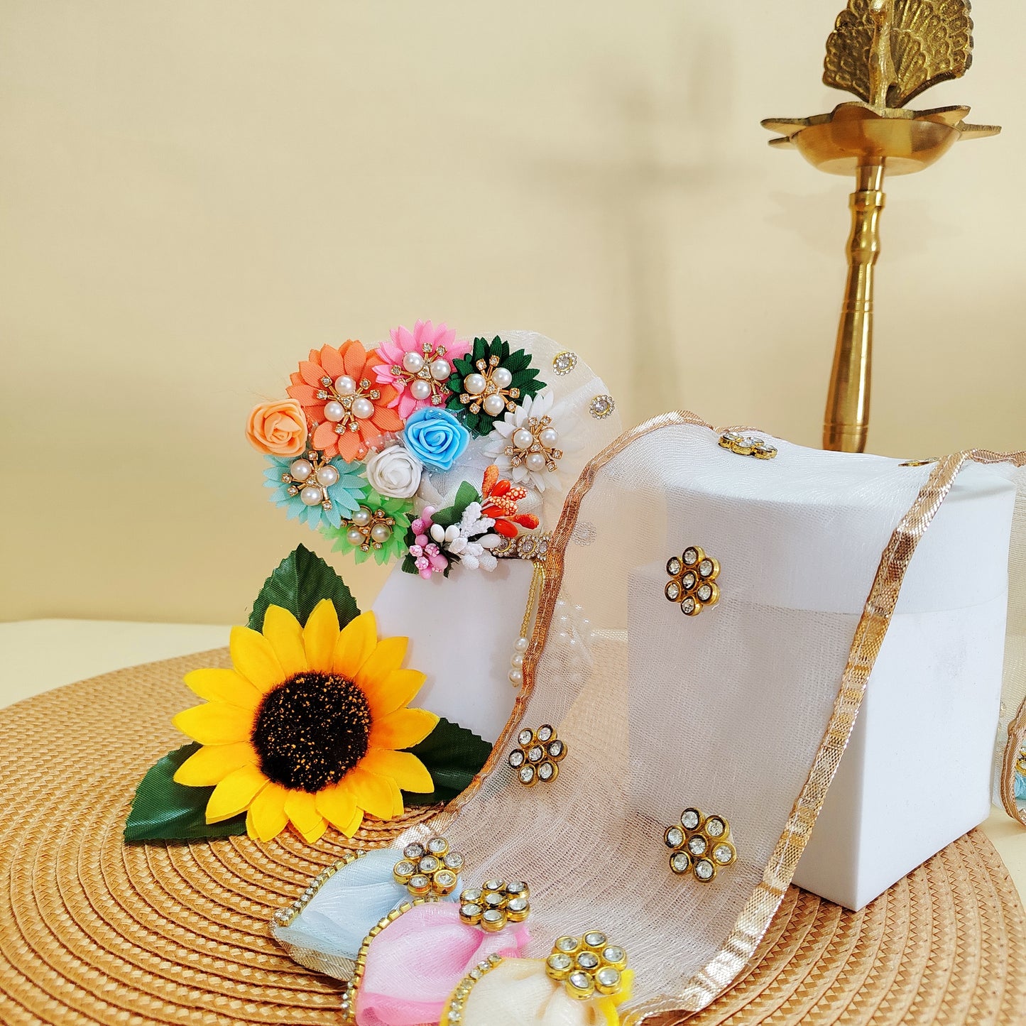 Assorted Pagdi and Chunri displayed on a woven mat with a neutral background