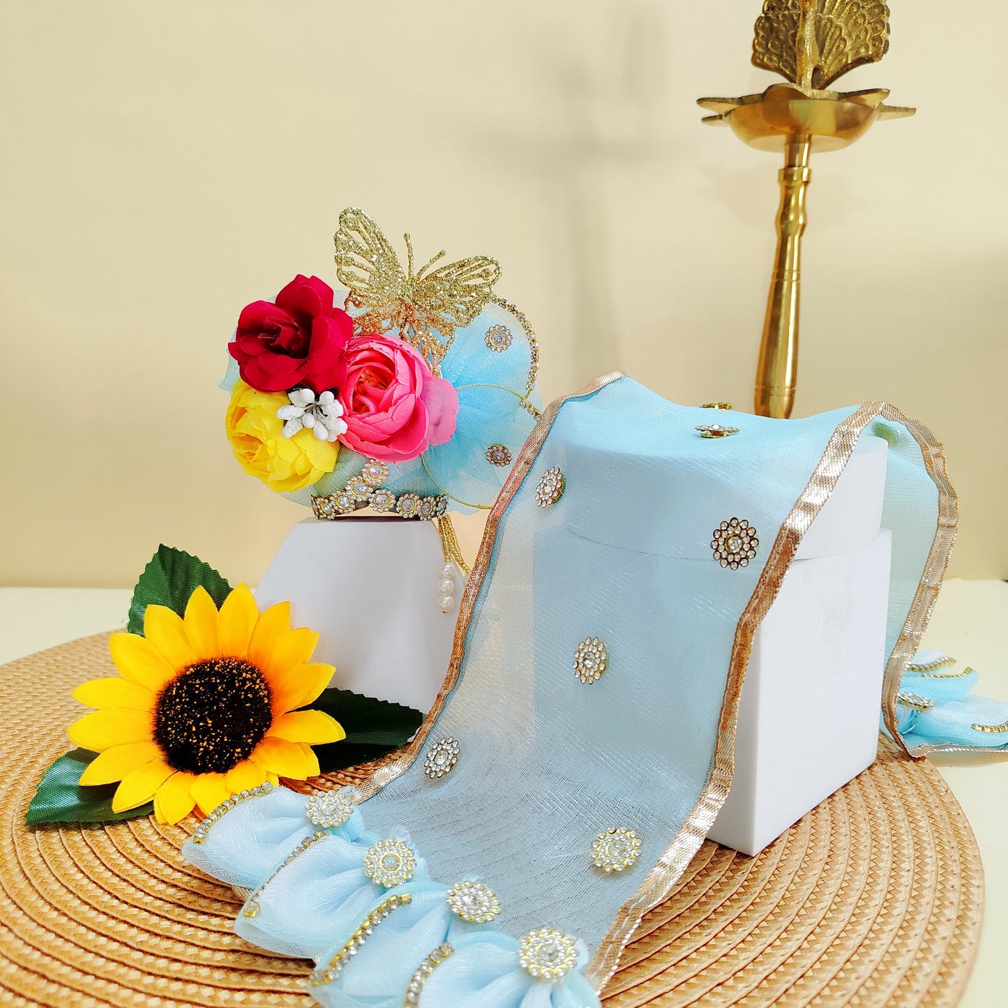 Decorative blue mukut with floral and butterfly design