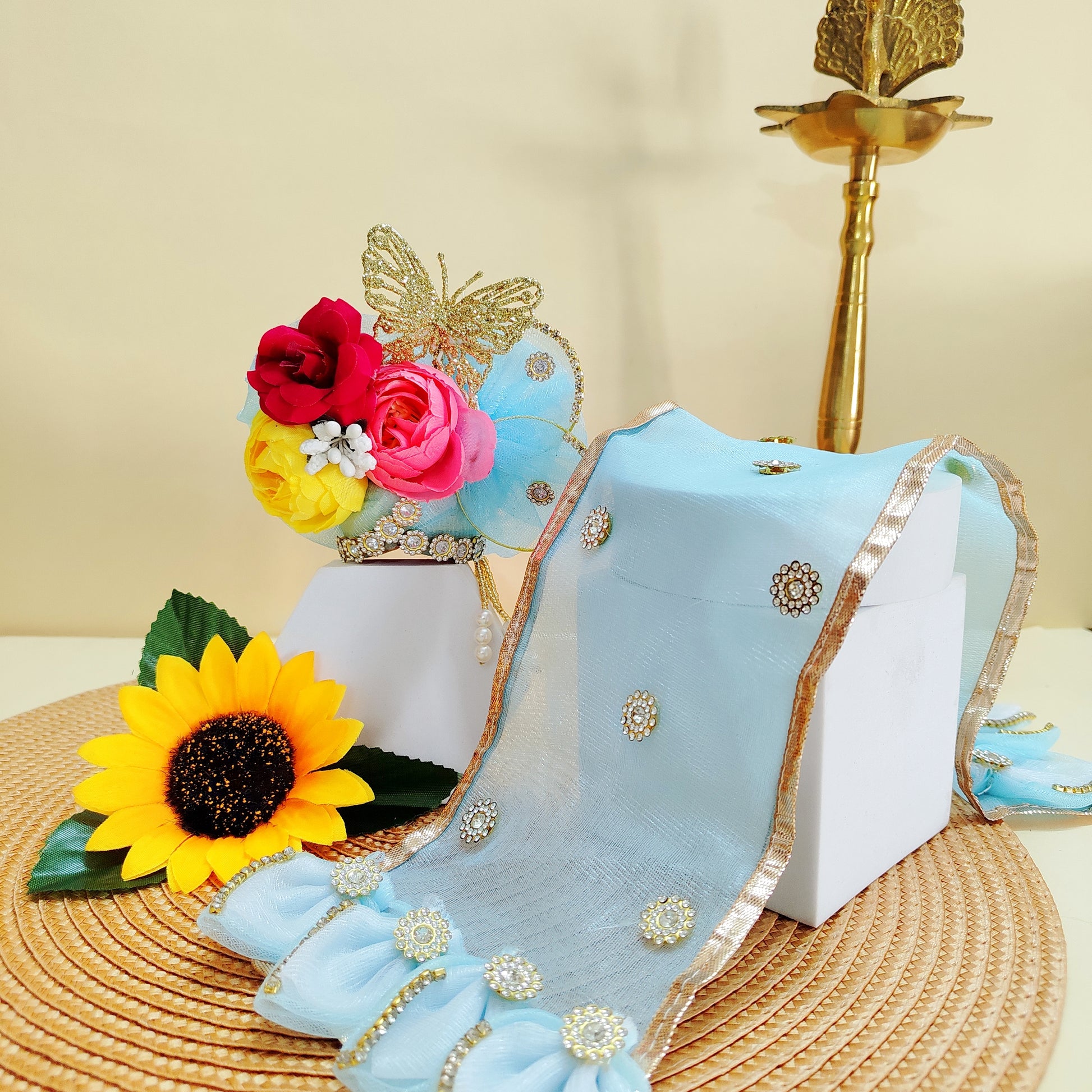 Decorative blue mukut with floral and butterfly design